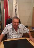 Rizkallah Aylo seated at a desk