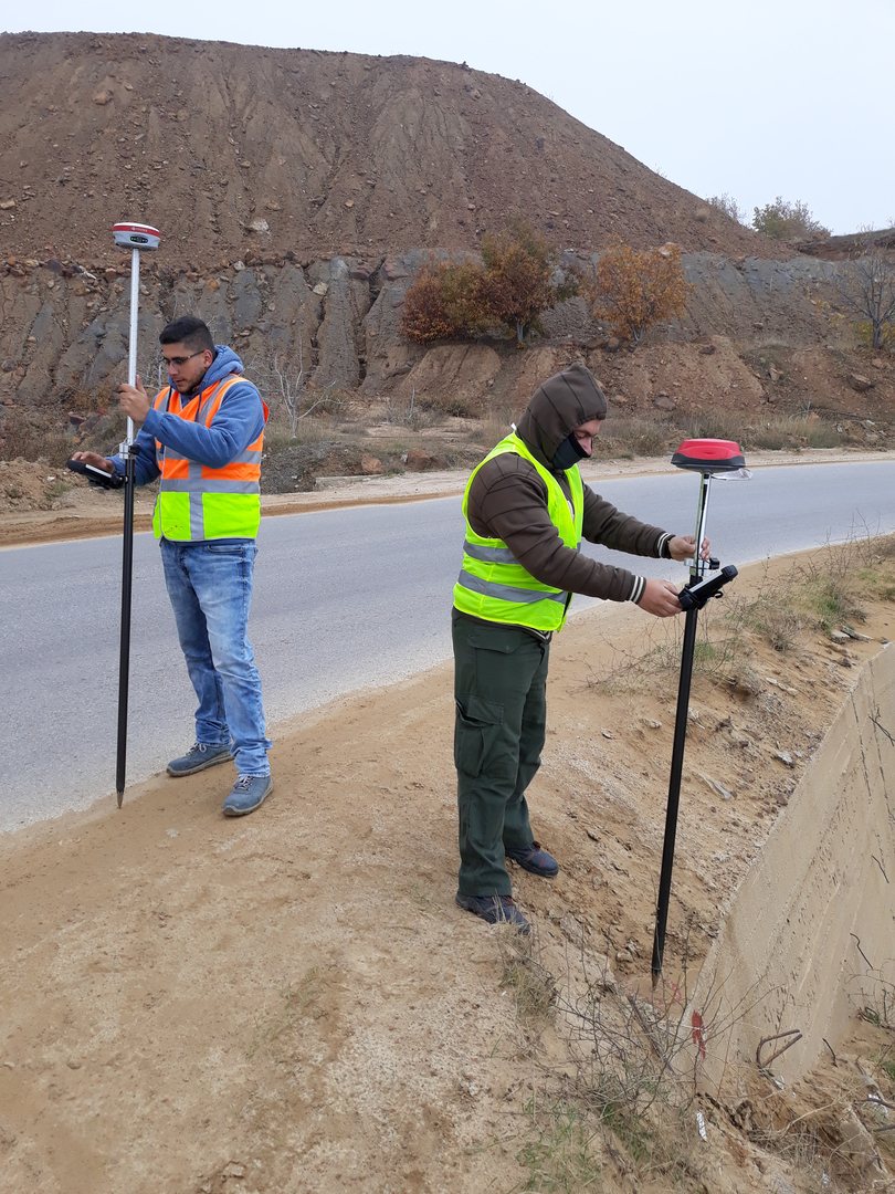 Field surveying team working in mountainous terrain